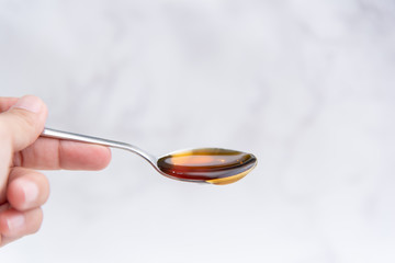 Honey in a spoon Held by a woman's hand