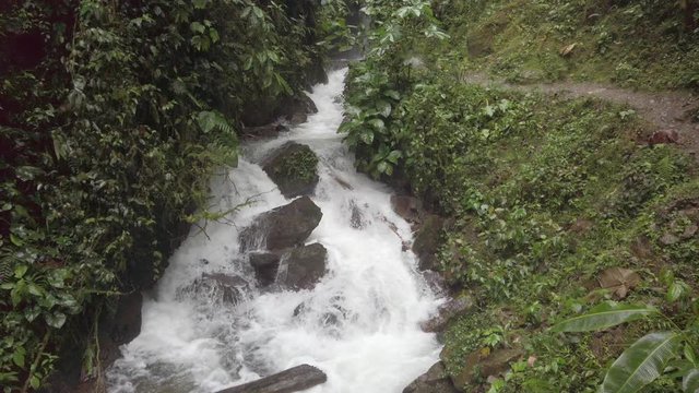 Waterfall in jungle forest at rainy cloudy day in Mindo, Ecuador