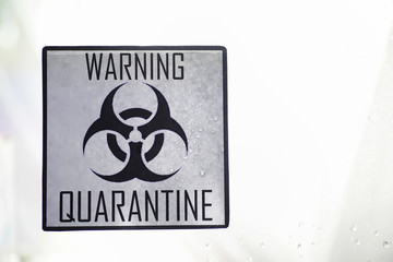 Quarantine. Quarantine warning sign on a glass door in a hospital isolator. Isolation of patients with the virus in special laboratories. Virus.