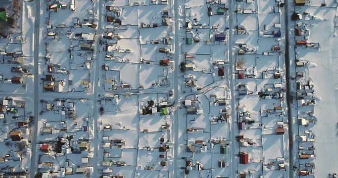 Top down view village with flat parallel street / No people in outdoors remote wild area at winter sunset - Aerial drone view