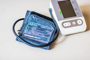 A blood pressure monitor laid on a table ready to be used