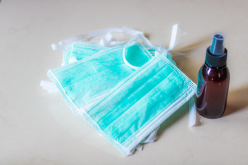 Face masks with a spray bottle full of sanitizer liquid ready for use during Covid19