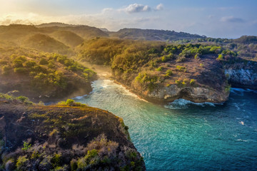 Magnificent view of unique natural rocks and cliffs formation in beautiful beach known as Angel's Billabong beach located in the east side of Nusa Penida Island, Bali, Indonesia. Aerial view.