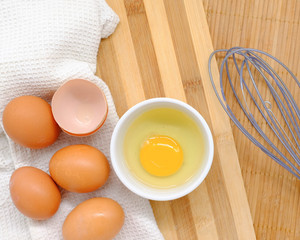 Close-up view of raw chicken eggs on background