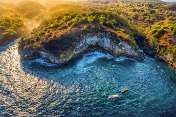 Magnificent view of unique natural rocks and cliffs formation in beautiful beach known as Angel's Billabong beach located in the east side of Nusa Penida Island, Bali, Indonesia. Aerial view.
