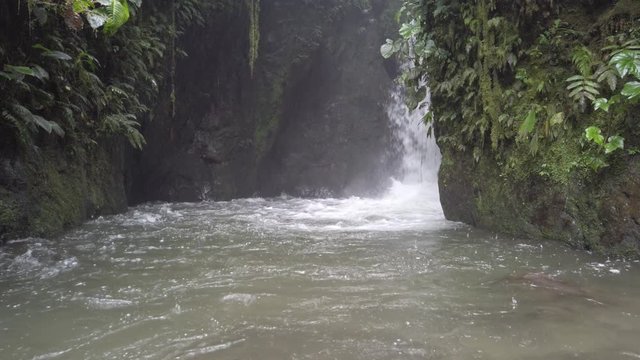 Waterfall in rainforest at rainy cloudy day in Mindo, Ecuador