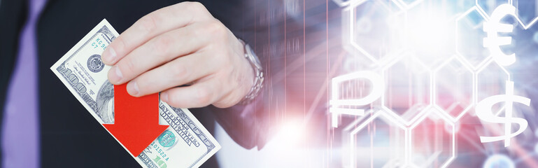 Financial crisis. Concept. Money bills in hand. Arrow symbol of the fall of the national currency. The change in the exchange rate between the Russian ruble and the US dollar.