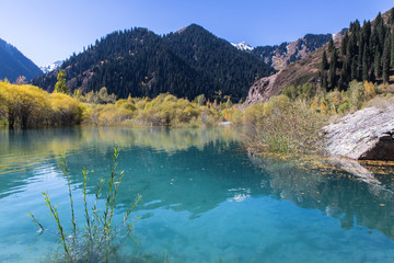 clear water with mountans reflection in Issyk lake in Kazakhstan