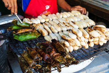 A street food vendor in Asia sells fried bananas and other snacks.