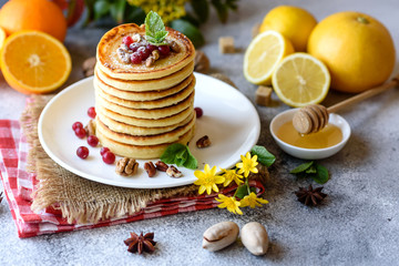 Obraz na płótnie Canvas Delicious fresh beautiful pancakes with citrus honey and jam