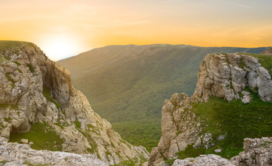 dramatic sunset over a top of mountain canyon