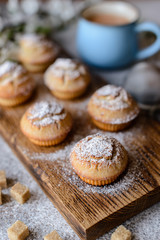 Fresh baked cupcakes of rice flour with banana and vanilla with a mug of hot chocolate
