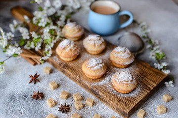 Fresh baked cupcakes of rice flour with banana and vanilla with a mug of hot chocolate