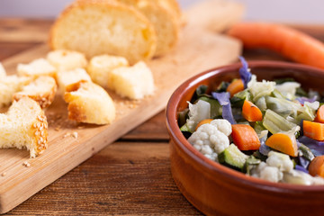 Mixed fresh vegetables with bread. Minestrone, detox food. 