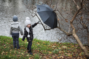 Children walk in the autumn park
