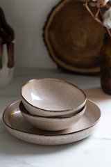 Brown rustic handmade kitchenware on white background. Ceramic dished in neutral tones, scandinavian style.