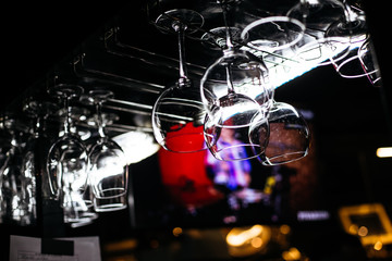 bar counter with glasses in a dark room