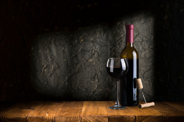 Wine bottles with glass, wooden background border