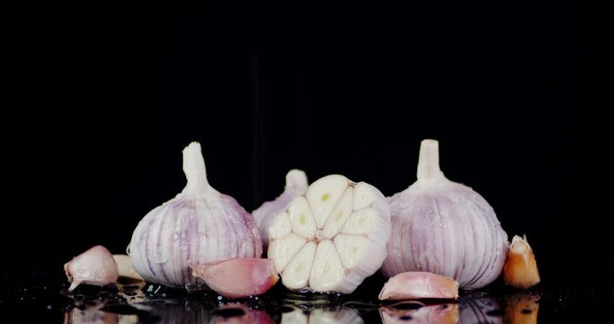 Fresh garlic falling water drops.