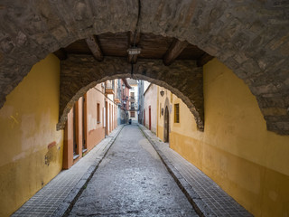 Colorful buildings in a small narrow street in the old town of Jaca, Huesca, Aragon, Spain