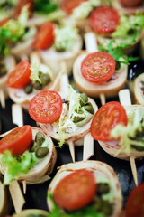 Beautifully decorated catering banquet table with salads and cold snacks.
