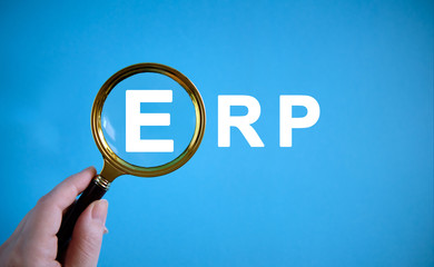 ERP - text with a magnifying glass on a blue background