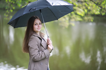 Young girl in a coat in a spring park