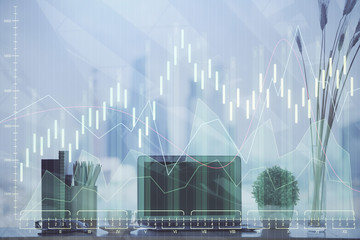 Double exposure of chart and financial info and work space with computer background. Concept of international online trading.