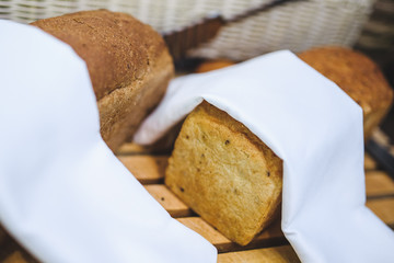 A loaf of bread under a kitchen towel