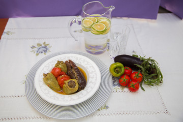 Eggplants are stuffed with meat lamb and rice. Patlican . eggplant filling . Eggplant, peppers, tomatoes . Yogurt in a brown bowl . Chopped lemon in a glass jar . Stuffed eggplant in the plate .