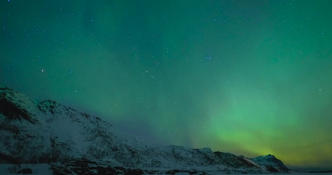 Northern Lights, polar light or Aurora Borealis in the night sky over the arctic landscape of the Lofoten islands in northern Norway. Time lapse video.