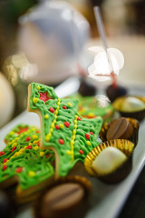 Gingerbread cookies in the form of a christmas tree with chocolate candies on a plate