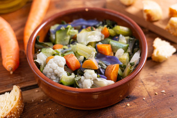 Mixed fresh vegetables with bread. Minestrone, detox food. 