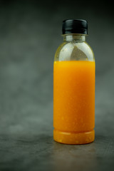 One plastic bottle with orange juice