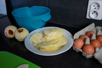 Peeling and slicing apples before making apple pie. Preparation of the dough for baking homemade pie.