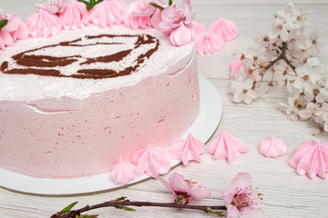 Pink marshmallow cake on a light background with a painted machine