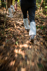 Motion blur of legs covered by white long socks.