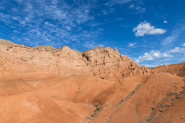 Fototapeta na wymiar baguty red sand mountains tourist attraction with cloudy sky near Almaty, Kazakhstan