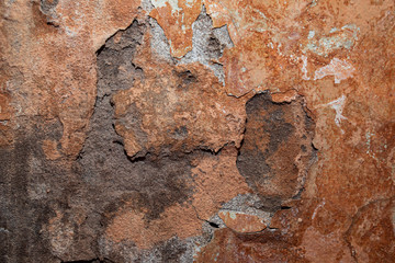 Old cracked paint concrete wall texture background. Fragment of an old wall with cracks