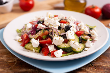 Greek salad with feta cheese, green peppers, black olives, tomatoes. Ideas for summer, light and fast lunch. Nutritious and complete food.