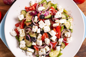 Greek salad with feta cheese, green peppers, black olives, tomatoes. Ideas for summer, light and fast lunch. Nutritious and complete food.