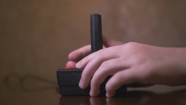 Child Playing With Vintage TV Video Game Joystick. 4K Footage