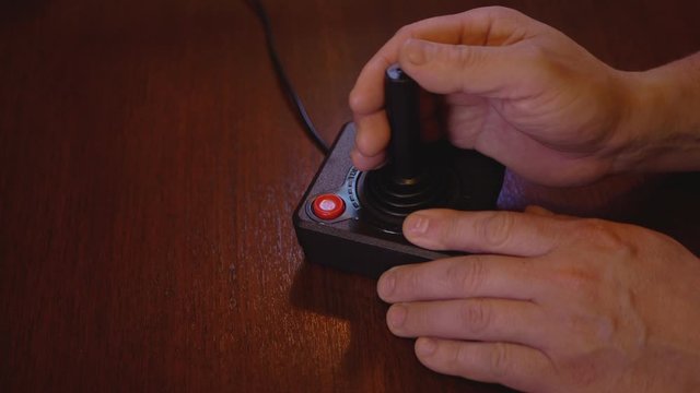 Man Playing With Vintage TV Video Game Joystick. 4K Slow-Motion Footage