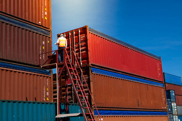 Fototapeta premium Marine and carrier insurance concept. Foreman control loading Containers box at shipping port. Business logistic Import and export concept.