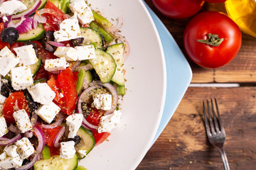 Greek salad with feta cheese, green peppers, black olives, tomatoes. Ideas for summer, light and fast lunch. Nutritious and complete food.