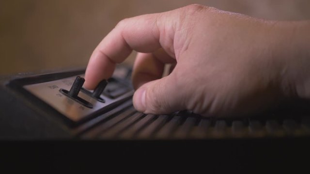 Man Manages Vintage TV Video Game Console Computer. 4K Footage