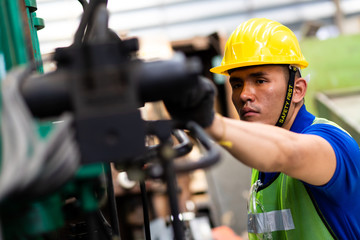 Mechanical Engineering control lathe machine in factory facility. Safety First at work place.