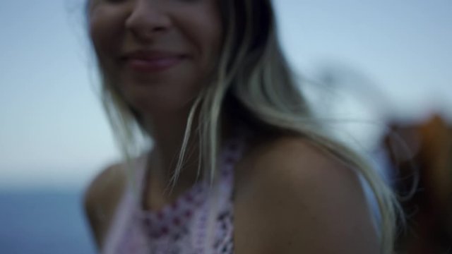 Lifestyle video, a young blonde smiling Caucasian woman in a dress enjoying the Peine del Viento city of San Sebastian one summer afternoon. Basque Country