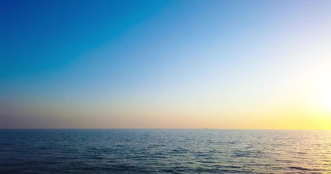 Timelapse and motion lapse of beautiful dramatic sunset over sea or ocean with dramatic sky and colorful clouds. 4K time lapse clip