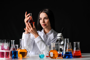 Female alchemist with potions at table